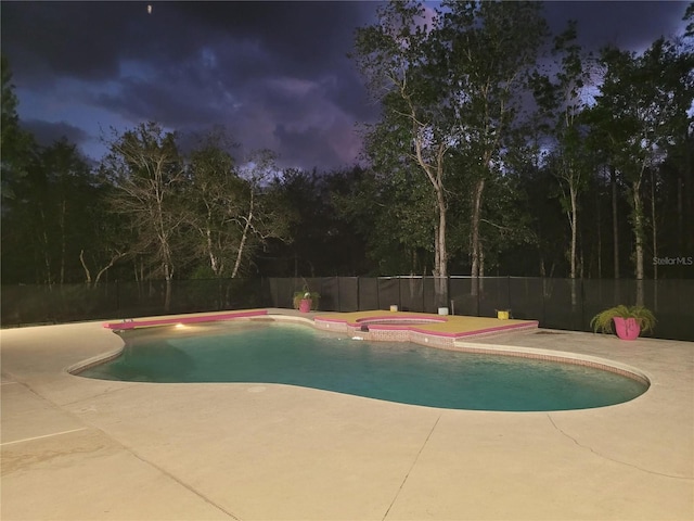 view of pool with a fenced backyard, a fenced in pool, an in ground hot tub, and a patio