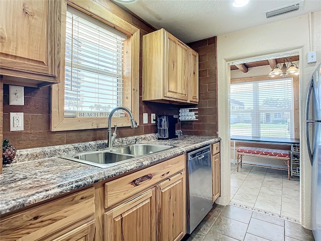 kitchen with visible vents, a sink, tasteful backsplash, appliances with stainless steel finishes, and light tile patterned flooring