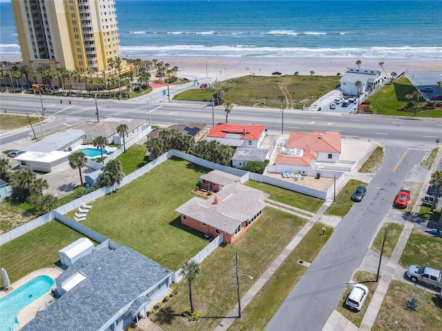 drone / aerial view featuring a water view and a beach view