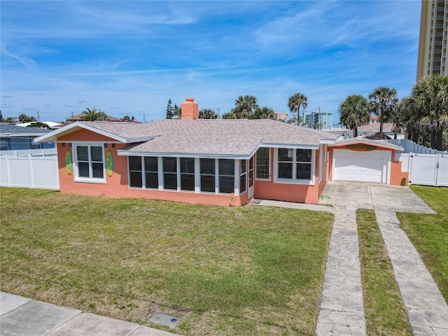 ranch-style home with fence, concrete driveway, roof with shingles, a front yard, and a gate