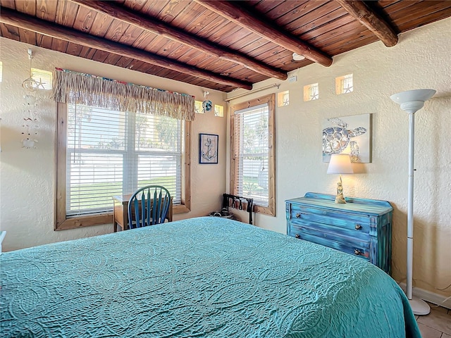 tiled bedroom featuring beamed ceiling, wooden ceiling, and a textured wall