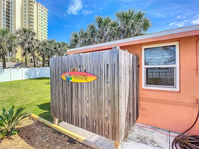 details featuring stucco siding and fence