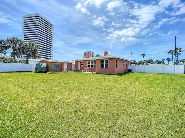 view of yard featuring an outdoor structure, central air condition unit, and a fenced backyard