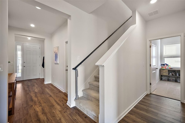 entryway with visible vents, dark wood-type flooring, baseboards, stairway, and recessed lighting