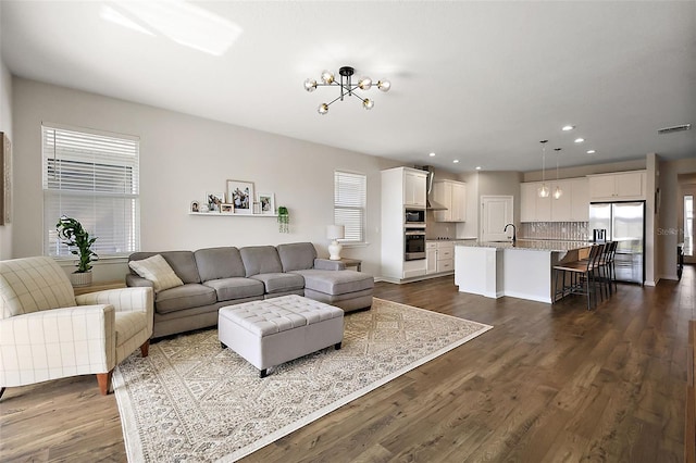 living room with dark wood finished floors, recessed lighting, and visible vents