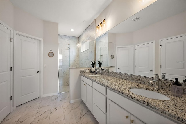 bathroom with visible vents, a walk in shower, baseboards, marble finish floor, and a sink