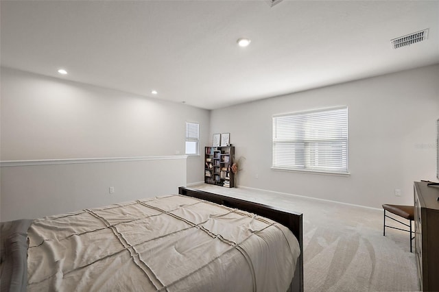 carpeted bedroom with recessed lighting, visible vents, and baseboards