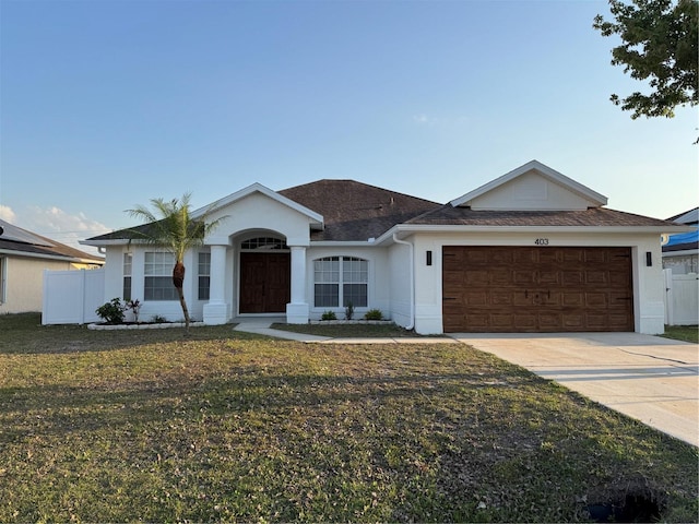 single story home with stucco siding, driveway, a front lawn, and a garage