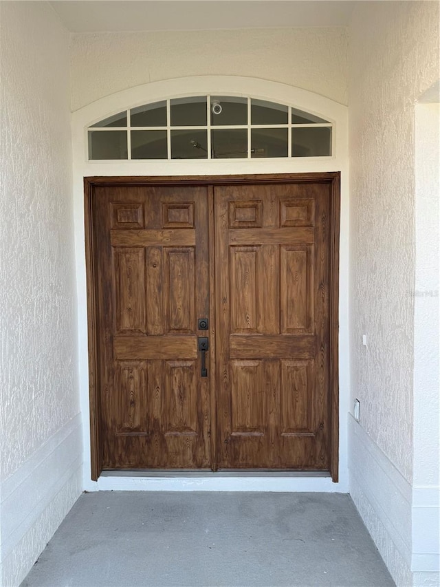 entrance to property featuring stucco siding