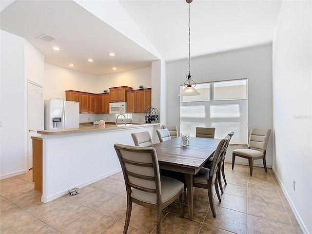 dining room with recessed lighting, visible vents, lofted ceiling, and baseboards