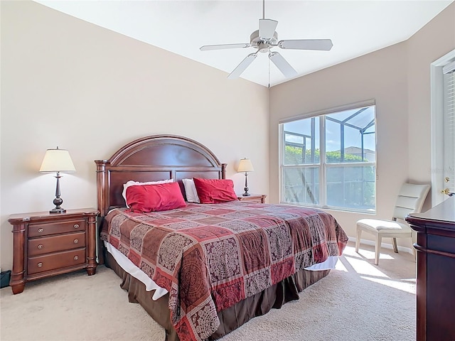 bedroom with light colored carpet and a ceiling fan