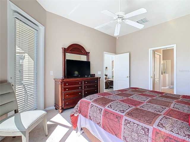 bedroom featuring connected bathroom, visible vents, light colored carpet, and ceiling fan