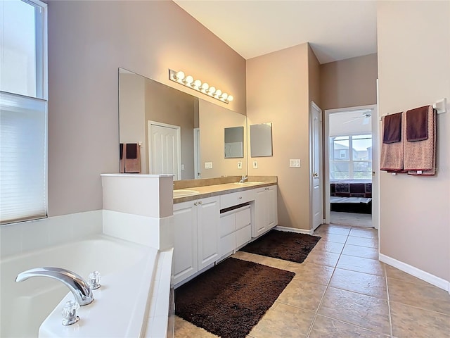 full bath featuring double vanity, a sink, tile patterned flooring, a garden tub, and connected bathroom