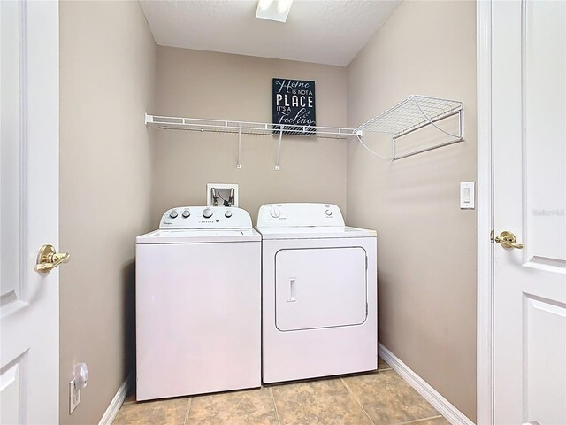 laundry room featuring baseboards, laundry area, and washer and clothes dryer