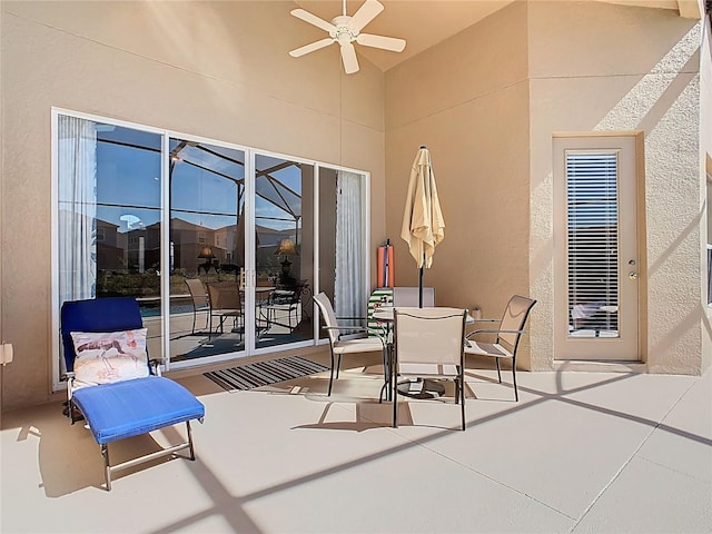 view of patio featuring outdoor dining area and a ceiling fan