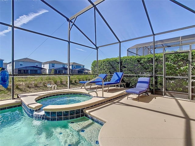 view of pool with a pool with connected hot tub, a lanai, and a patio area