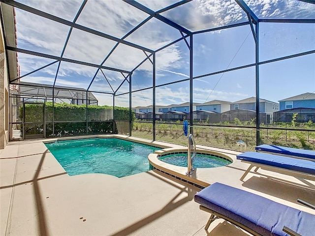 view of swimming pool with a patio, a residential view, a pool with connected hot tub, and a lanai