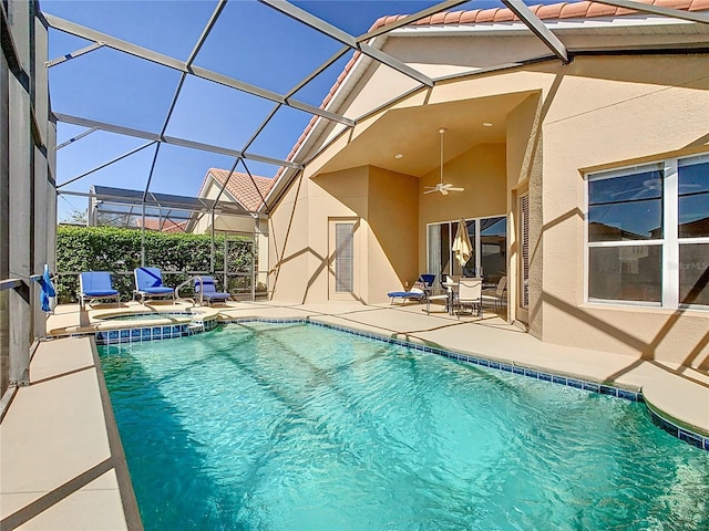 view of pool with a patio, a pool with connected hot tub, a lanai, and ceiling fan