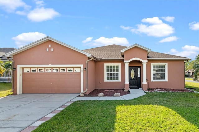 ranch-style house featuring stucco siding, an attached garage, concrete driveway, and a front lawn