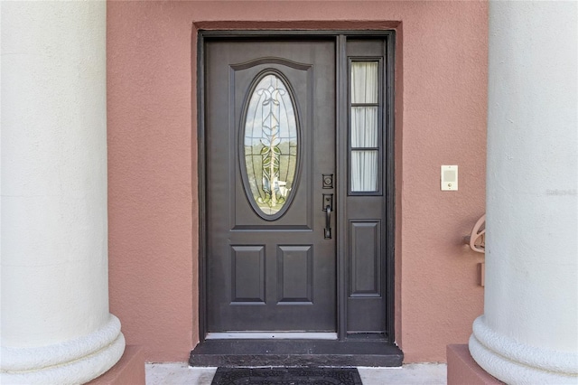 property entrance featuring stucco siding