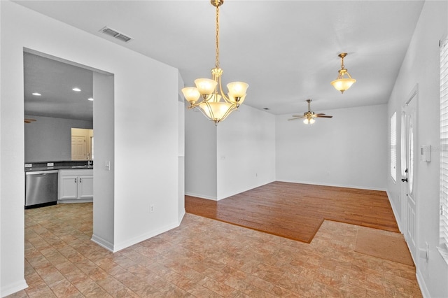 empty room featuring visible vents, baseboards, recessed lighting, light wood-style floors, and ceiling fan with notable chandelier