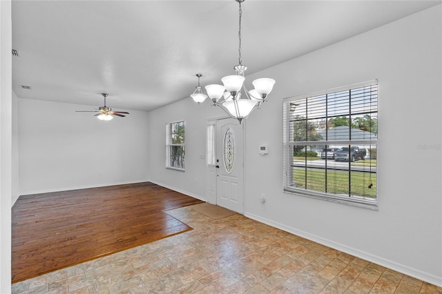 foyer entrance featuring visible vents, ceiling fan with notable chandelier, baseboards, and wood finished floors