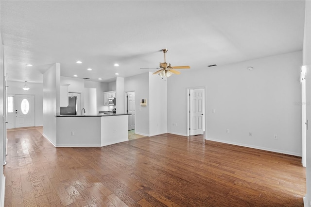 unfurnished living room with recessed lighting, baseboards, ceiling fan, and hardwood / wood-style flooring