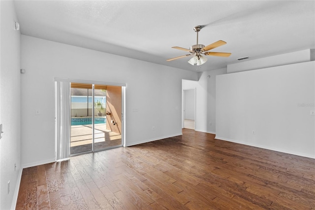 unfurnished room with visible vents, wood finished floors, baseboards, and ceiling fan