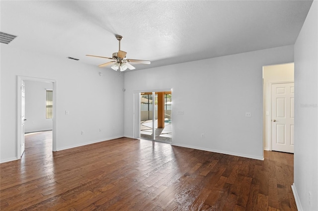 empty room featuring wood finished floors, visible vents, and ceiling fan