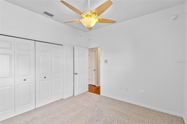 unfurnished bedroom with a ceiling fan, baseboards, visible vents, carpet floors, and a closet