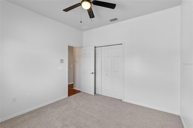 unfurnished bedroom with visible vents, baseboards, a closet, and carpet flooring