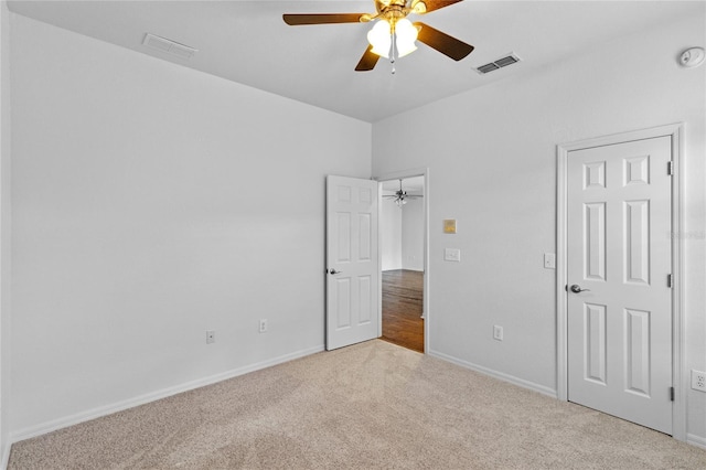 unfurnished bedroom with visible vents, baseboards, a ceiling fan, and carpet flooring