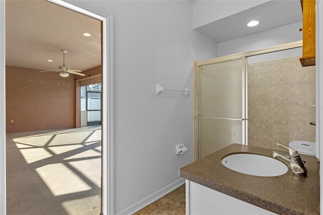 full bathroom with a shower with door, baseboards, ceiling fan, recessed lighting, and vanity