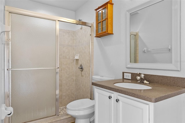 bathroom featuring a stall shower, toilet, and vanity