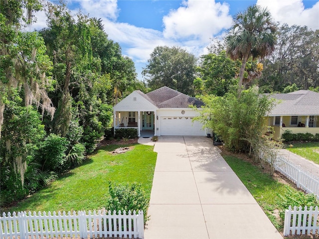 view of front of property with a front lawn, a porch, fence, concrete driveway, and a garage