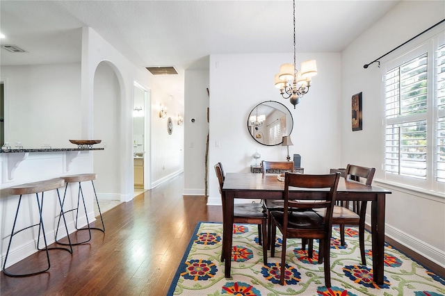 dining space with visible vents, a healthy amount of sunlight, baseboards, and wood-type flooring