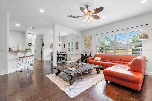 living room with visible vents, a ceiling fan, baseboards, and wood finished floors