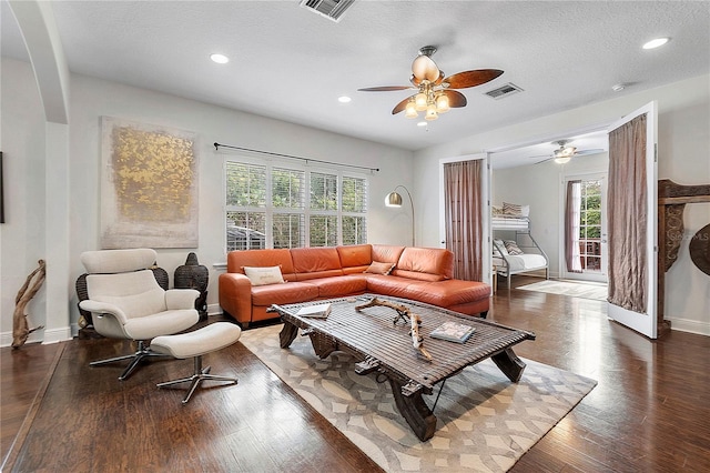 living area with visible vents, baseboards, and wood finished floors