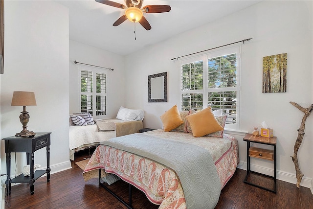 bedroom featuring baseboards, wood finished floors, and a ceiling fan