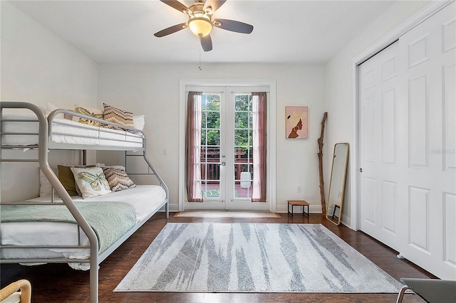 bedroom with french doors, baseboards, wood finished floors, and access to outside