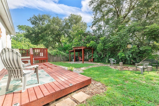 deck with a lawn, a pergola, and fence