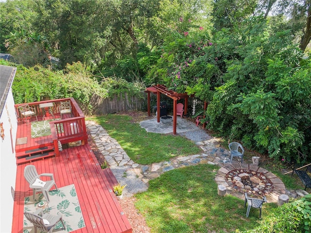 view of yard with a patio, a fire pit, and fence