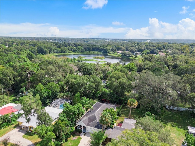 aerial view with a wooded view and a water view