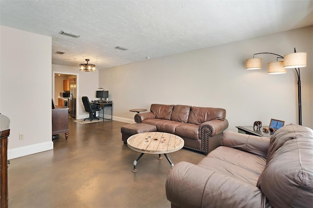 living room with visible vents, a textured ceiling, concrete flooring, and baseboards