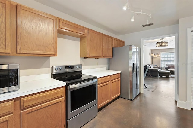 kitchen with visible vents, appliances with stainless steel finishes, light countertops, and finished concrete floors