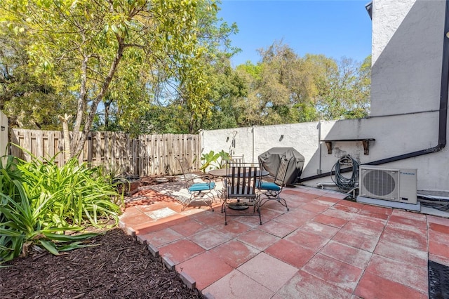 view of patio with ac unit and a fenced backyard