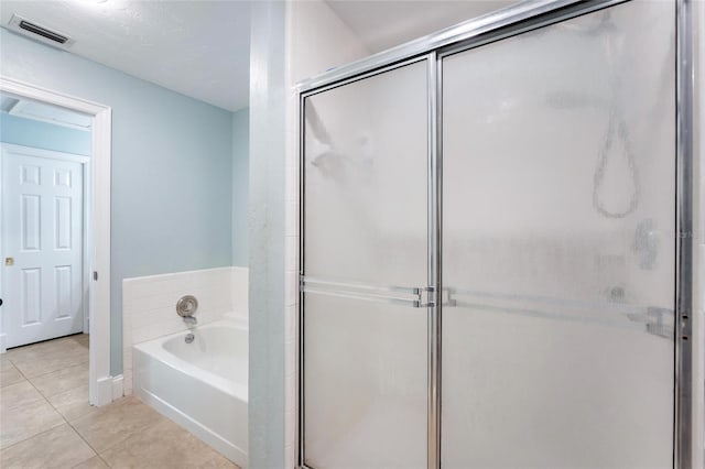 bathroom with baseboards, visible vents, a shower stall, tile patterned floors, and a bath