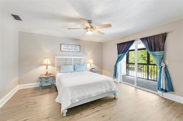 bedroom with visible vents, wood finished floors, baseboards, and access to exterior