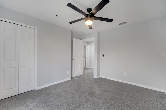 unfurnished bedroom featuring visible vents, ceiling fan, baseboards, carpet, and a closet