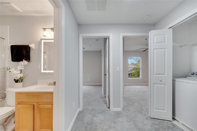 2026 Cypress Bay Blvd, Kissimmee, FL 34743 - bathroom with washer / dryer, vanity, and a shower